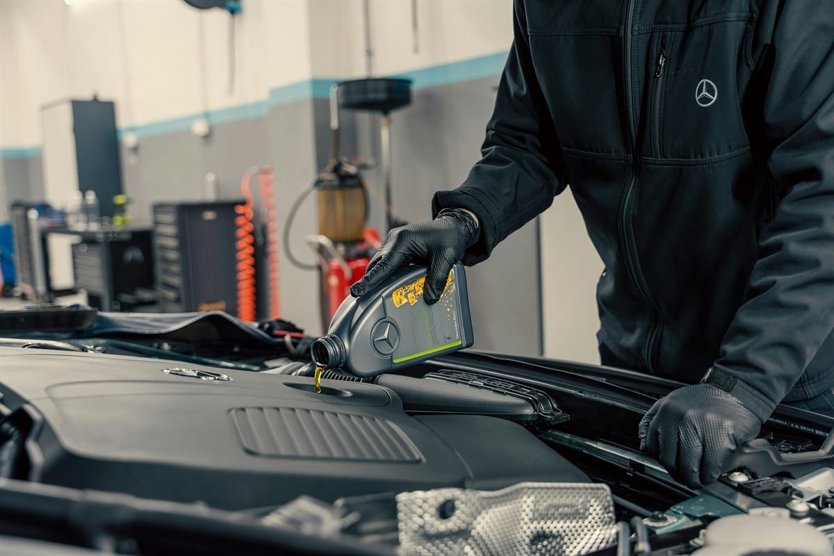 Atlanta Auto Repair Pro mechanic performing on-site oil and fluid service